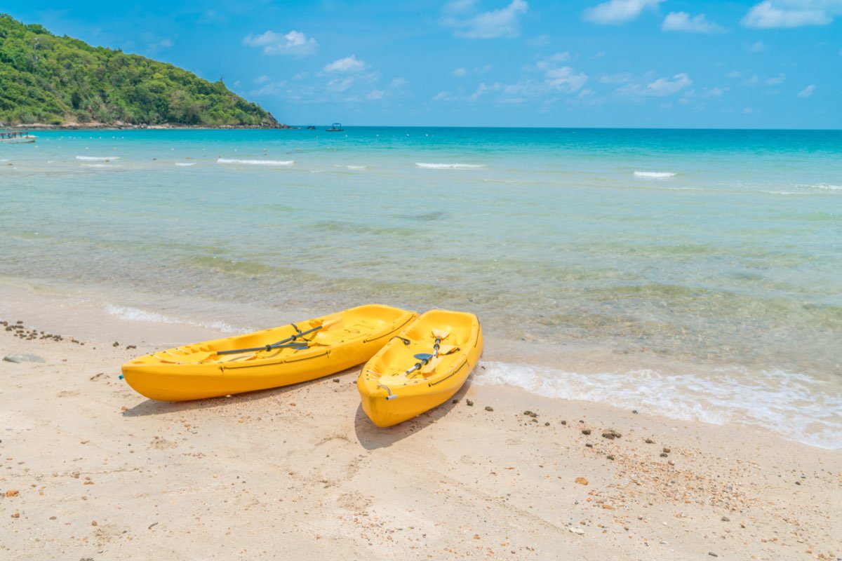 Yellow kayaks on a tropical beach with turquoise water